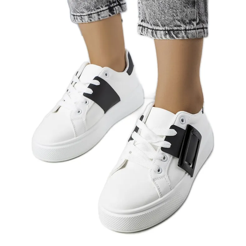 White sneakers decorated with a black Toni buckle