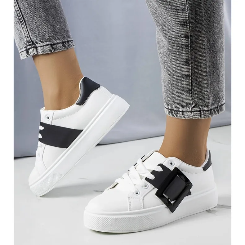 White sneakers decorated with a black Toni buckle